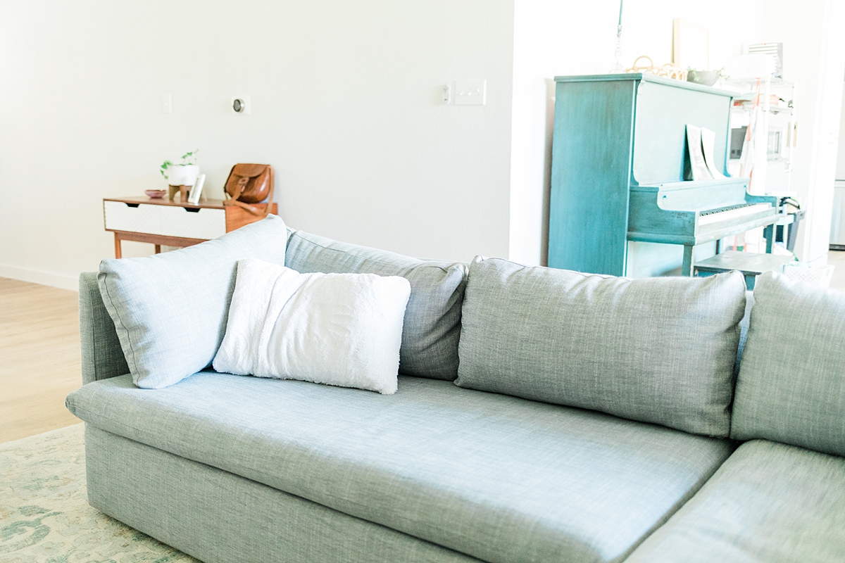 Our living room has a heathered blue West Elm couch we got from the outlet in San Marcos! We're in South Austin, Texas in a neighborhood called Cherry Creek. Click through to see how we've settled so far!