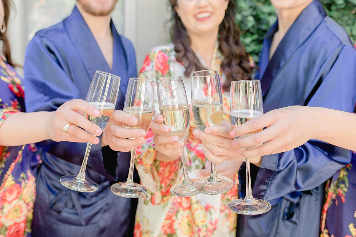 Champagne cheers in matching robes! Austin Texas wedding photographer. Click through to see all the beautiful details from this wedding!