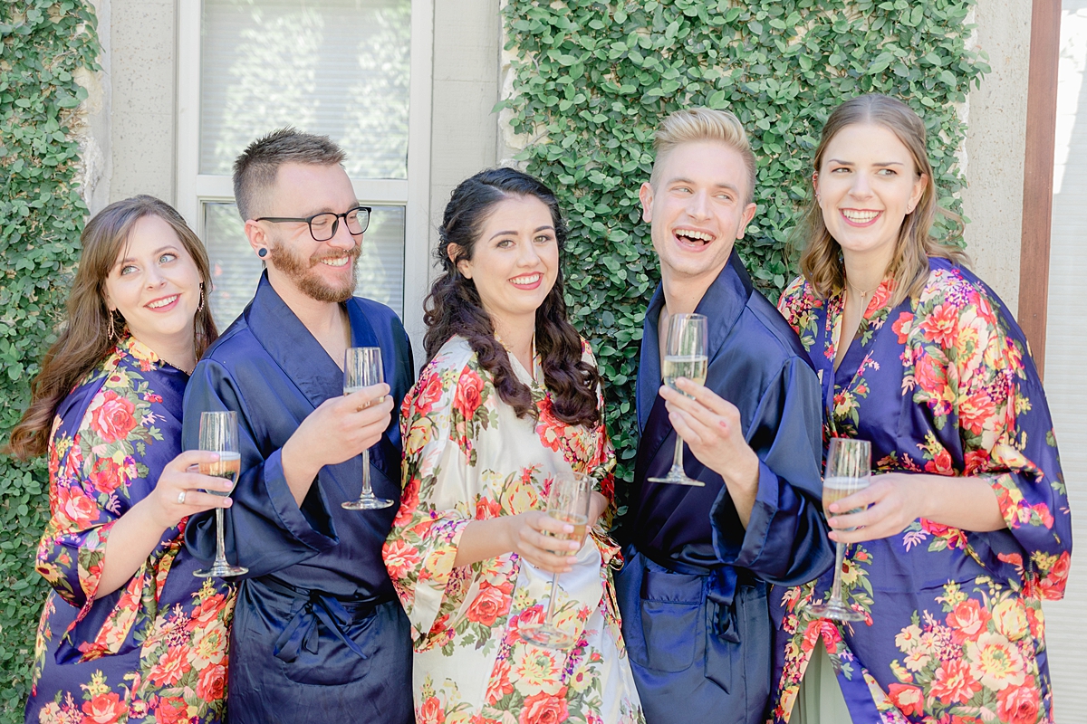 Champagne cheers in matching robes! Austin Texas wedding photographer. Click through to see all the beautiful details from this wedding!