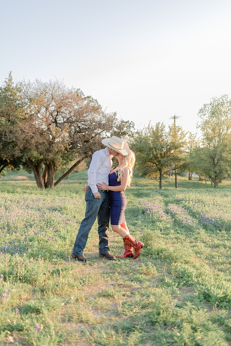 Those red cowboy boots though...! This engagement session in the Texas bluebonnets is just perfect! Outfit inspiration for sure!!! Steph is a reporter for Studio 512 and Aaron is a firefighter. Click through to read their story! 