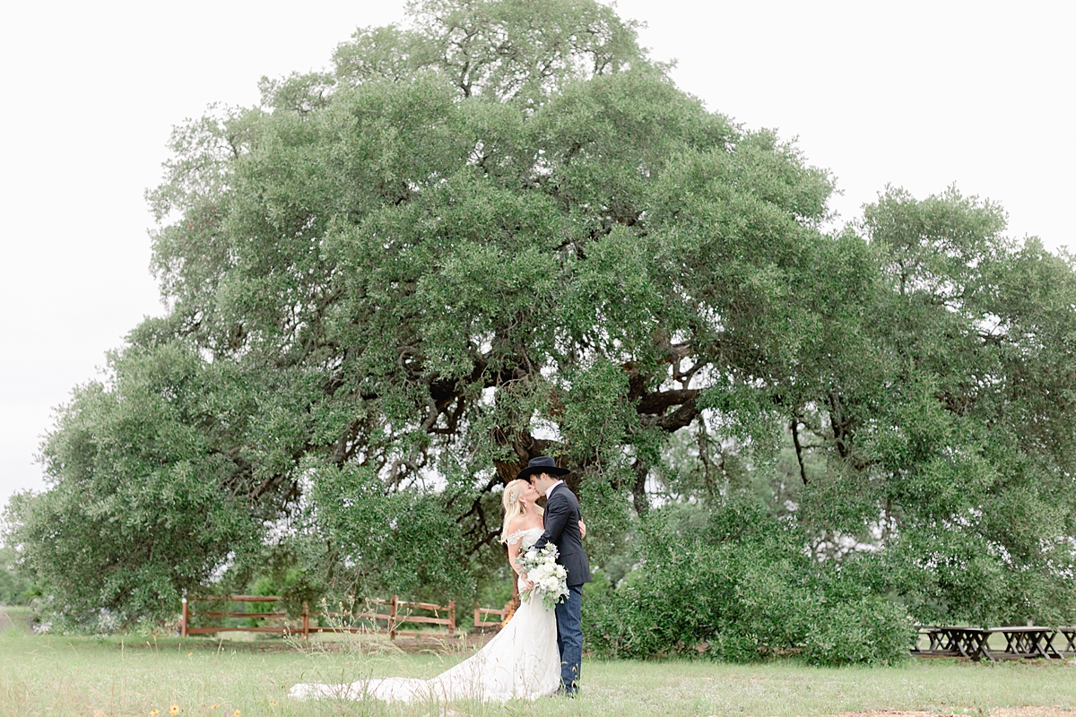 Husband and wife portraits during sunset! This beautiful summertime wedding at The Alexander at Creek Road features a beautiful ourdoor reception and ceremony under a huge oak tree.