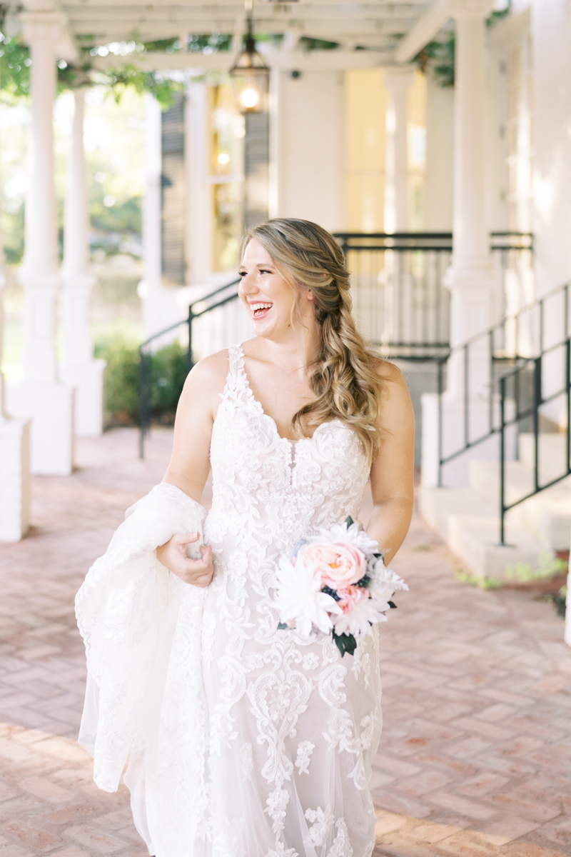 Bridal session at the brand new Austin wedding venue Woodbine Mansion, a historic 19th century home in Round Rock. Classic half up half down bridal updo with a floral hairpiece. 