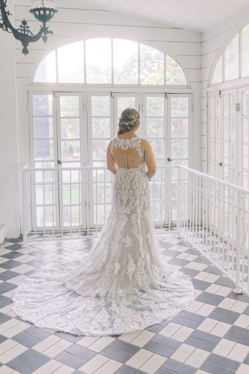 Bridal session at the brand new Austin wedding venue Woodbine Mansion, a historic 19th century home in Round Rock. Classic half up half down bridal updo with a floral hairpiece. 