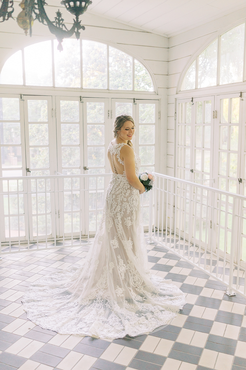 Bridal session at the brand new Austin wedding venue Woodbine Mansion, a historic 19th century home in Round Rock. Classic half up half down bridal updo with a floral hairpiece. 