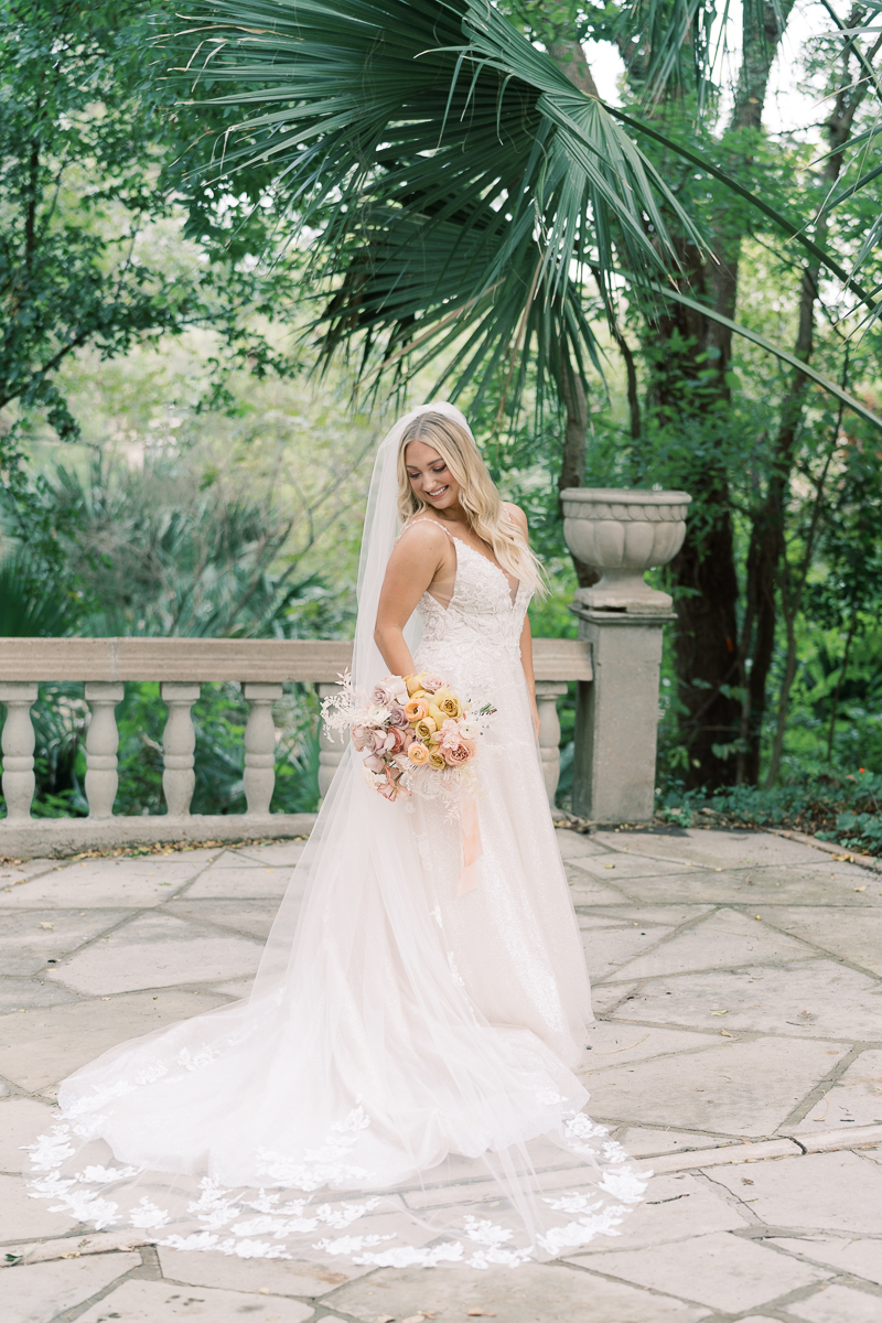 This bridal session at Laguna Gloria is the perfect classic, romantic bridals! With florals from Remi + Gold and the most sparkly, glitter wedding dress! 