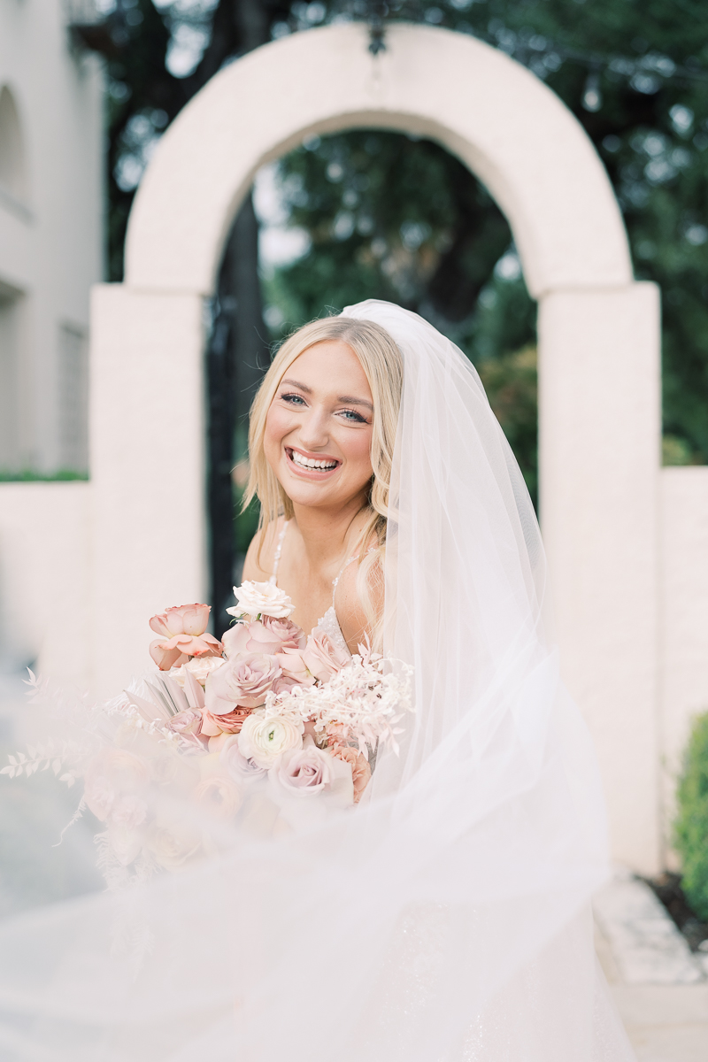This bridal session at Laguna Gloria is the perfect classic, romantic bridals! With florals from Remi + Gold and the most sparkly, glitter wedding dress!