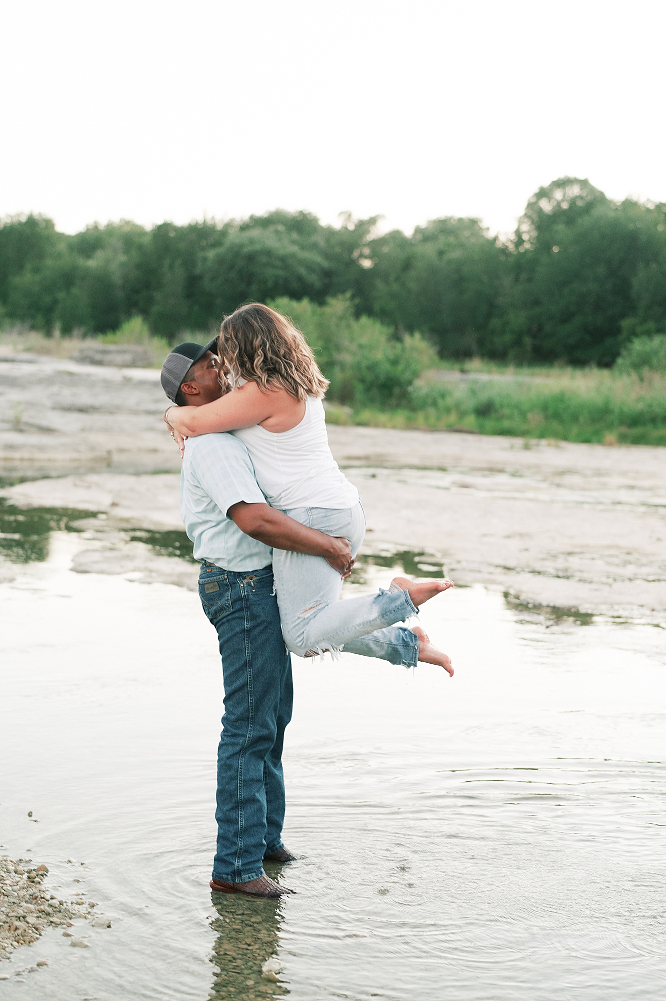 This beautiful bride to be DIY'd her own denim bridal jacket, to go with her flowy pink tulle skirt. This created the perfect outfit for her engagement session at McKinney Falls! Click through to see her outfit inspo and see how adorable she is with her fiance! #engagementsession #atxengagementsession #engagementsessionlocations #engagementsessionoutfit