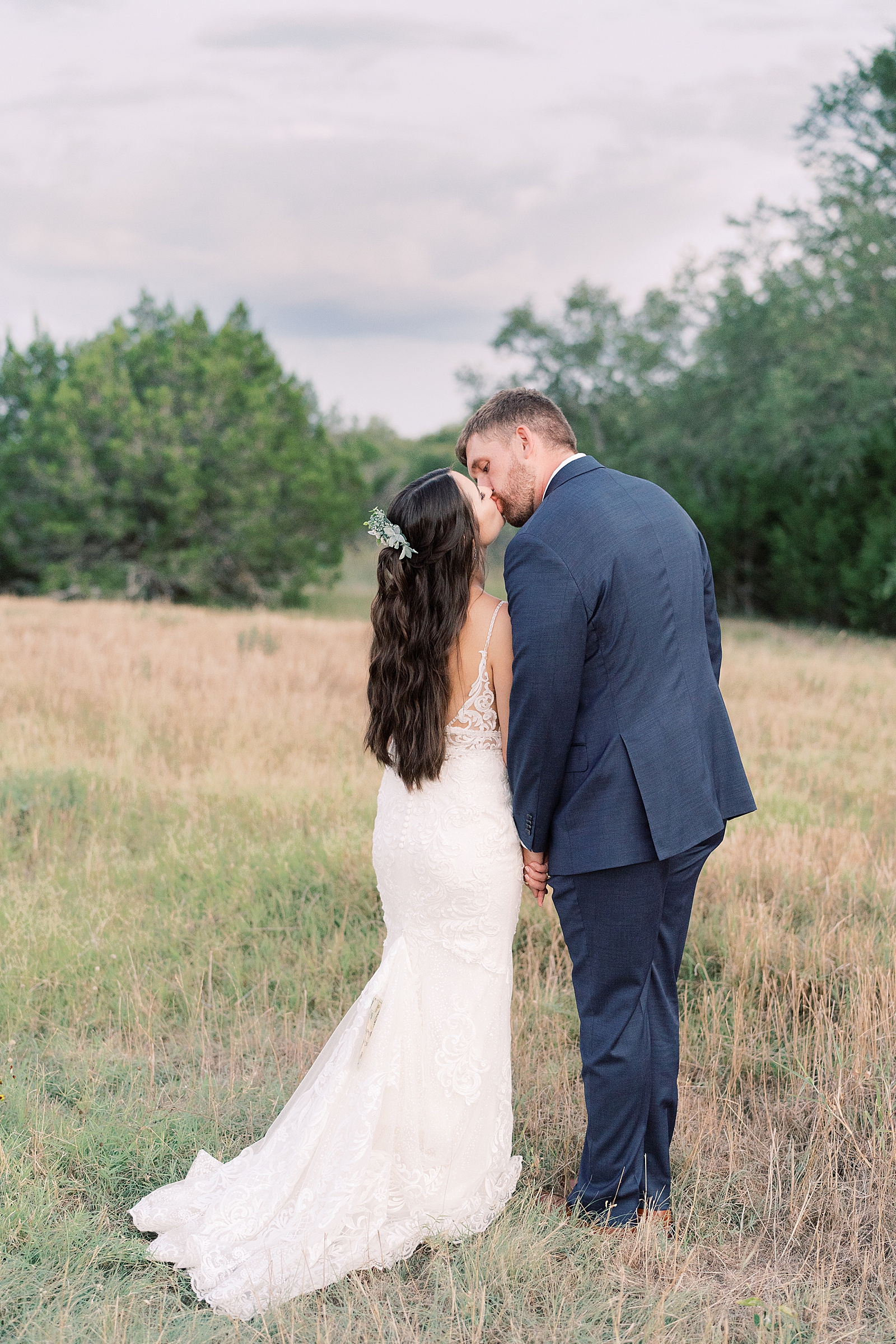 This navy, light gray, with pops of burgundy wedding day is some serious color palette inspo! In Dripping Springs, Texas at Saddle Creek Weddings, this day was full of elegance, fun and thoughtful details. Click through to see all the pretty! #weddingdayinspiration #dustybluewedding #austintexaswedding #hillcountrywedding 