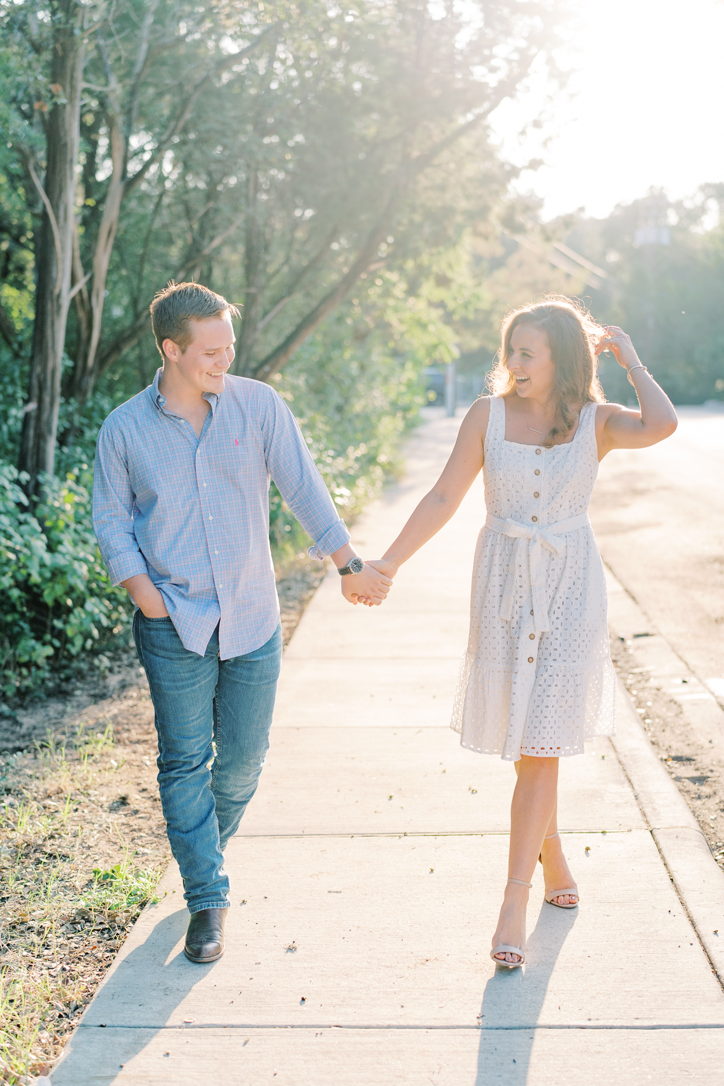 Popping champagne and watching the sunset over the lake? The best way to end a Laguna Gloria engagement session in my eyes!! This is my favorite Austin, TX engagement session location ever! Click through to see how adorable Emily and Trevor are...and see some serious outfit inspo! #engagementsessionoutfitinspo #atxengagementsession #lagunagloria