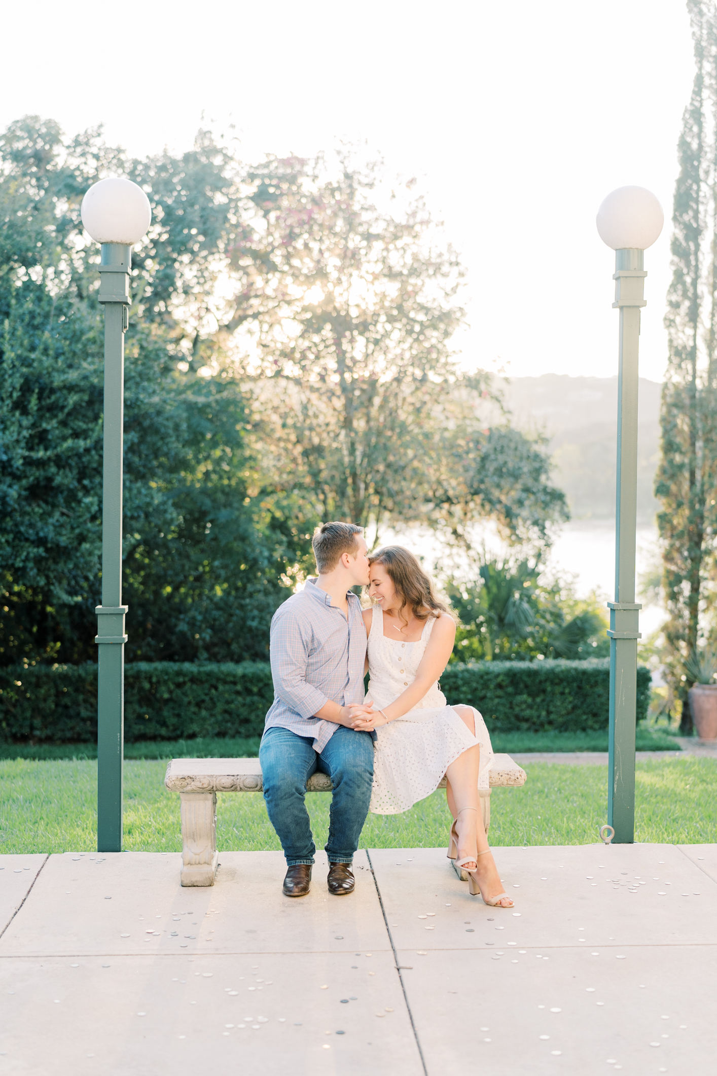 Popping champagne and watching the sunset over the lake? The best way to end a Laguna Gloria engagement session in my eyes!! This is my favorite Austin, TX engagement session location ever! Click through to see how adorable Emily and Trevor are...and see some serious outfit inspo! #engagementsessionoutfitinspo #atxengagementsession #lagunagloria