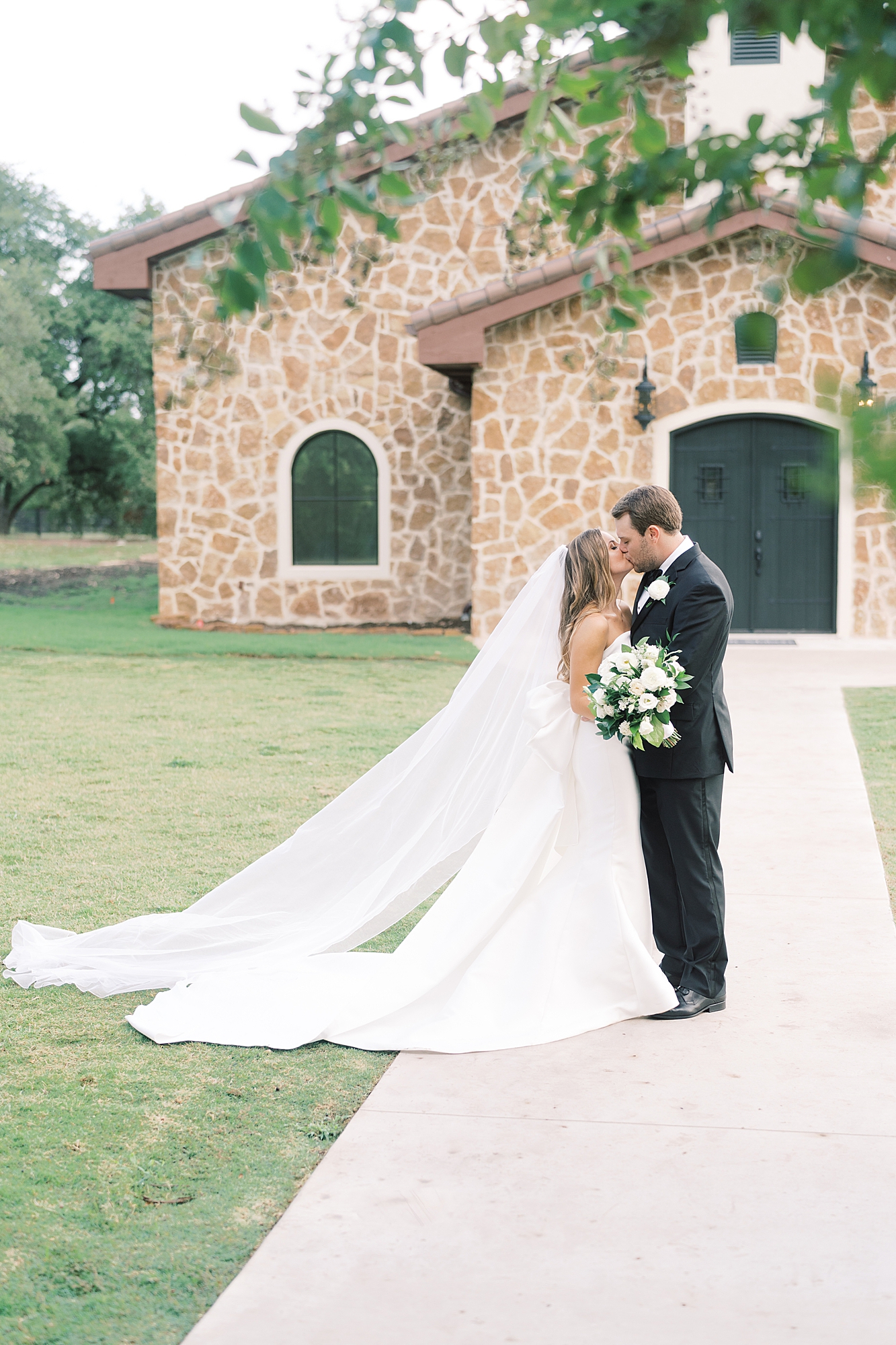This classic Ma Maison wedding in Dripping Springs was perfection! Their ceremony was inside the brand new cathedral at Ma Maison. A string trio played, and the grooms' father officiated. Click through to see all the beautiful photos from their day! (p.s. you have to see the bride's dress!) 