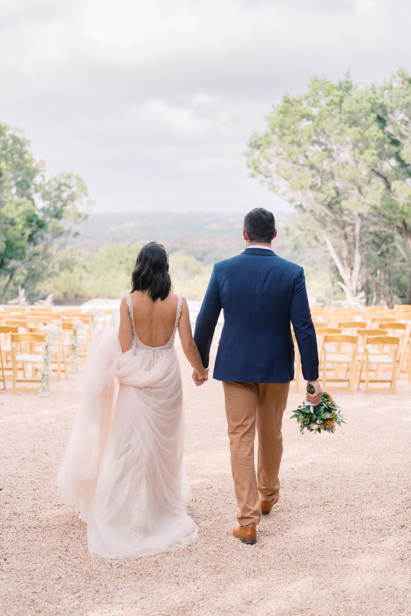 Pink, peach, navy and golden yellow make up my favorite trendy wedding color pallet - it's official! This wedding at this camp/hotel wedding venue is such a dream, you have to see! Set in the Texas hill country in Dripping Springs (with the most gorgeous view) Lucky Arrow Retreat is such a gem of a wedding venue! Click through to see Megan's BHLDN sparkly wedding dress, her perfect details, and the best party under the stars!