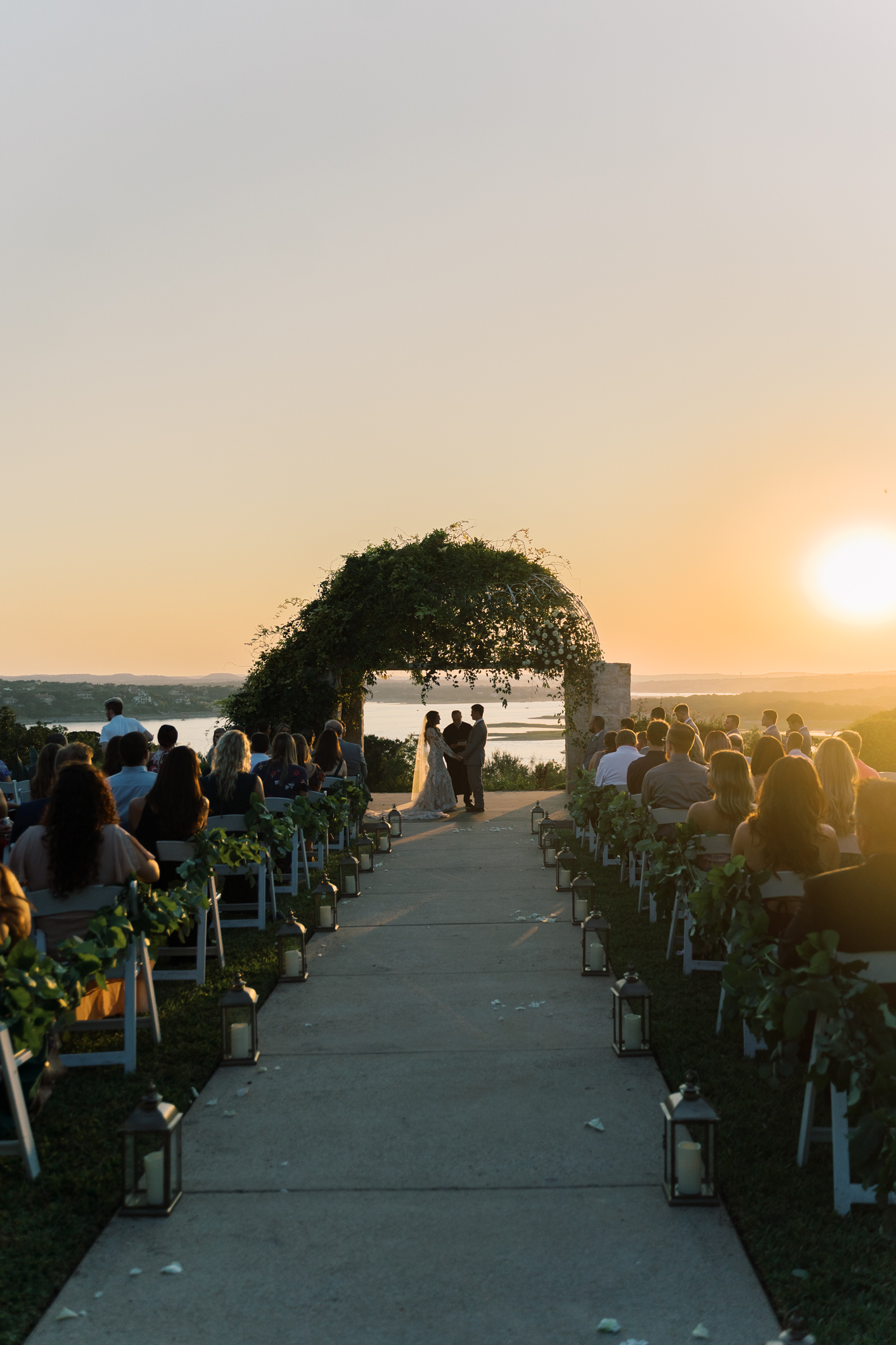 Jac's boho sheer, form fitting lace dress with gorgeous long sleeves is to die for! Their wedding day at Vintage Villas in Lakeway TX (near Austin) has the most beautiful sunset overlooking the water. You have to see for yourself! 