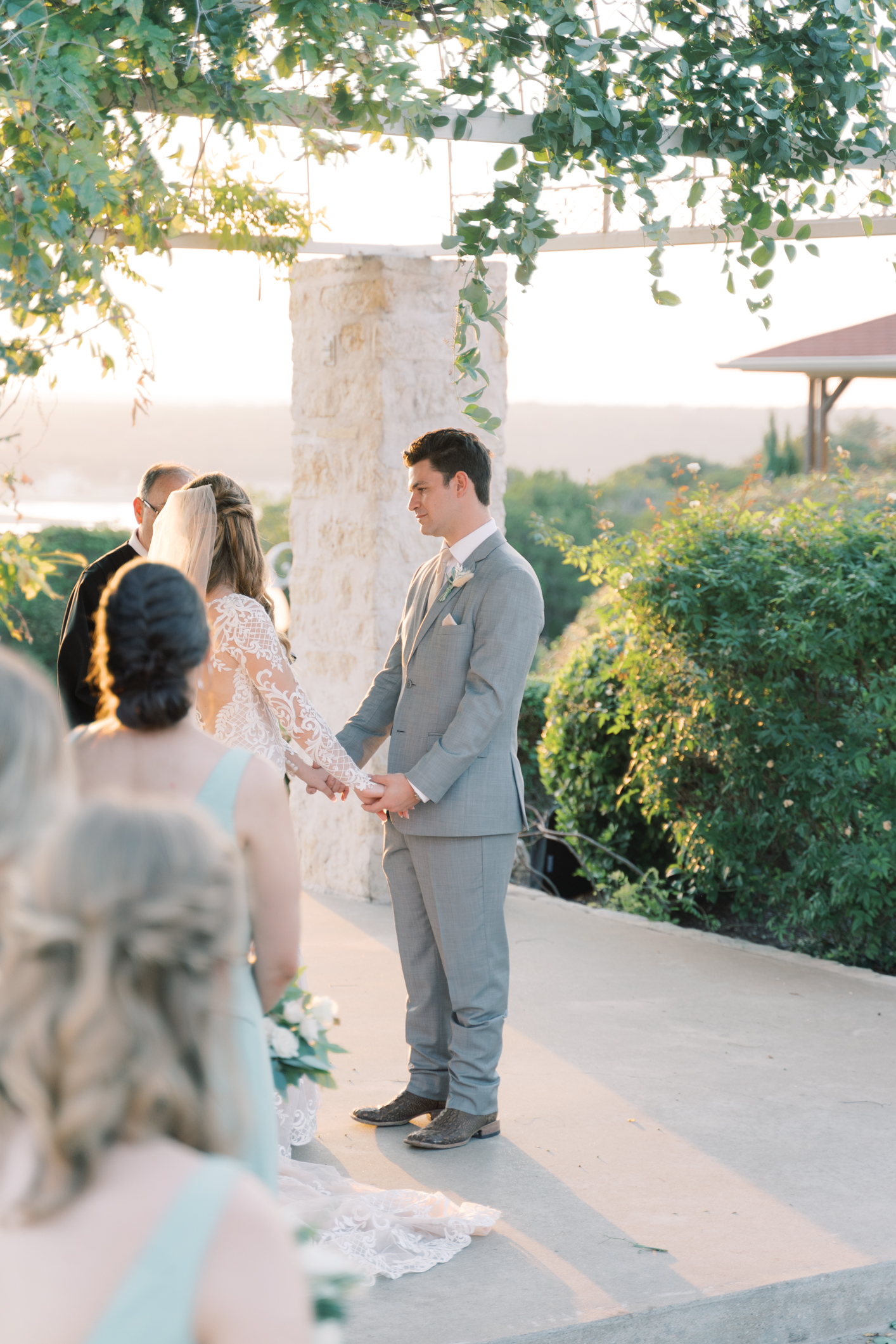Jac's boho sheer, form fitting lace dress with gorgeous long sleeves is to die for! Their wedding day at Vintage Villas in Lakeway TX (near Austin) has the most beautiful sunset overlooking the water. You have to see for yourself! 