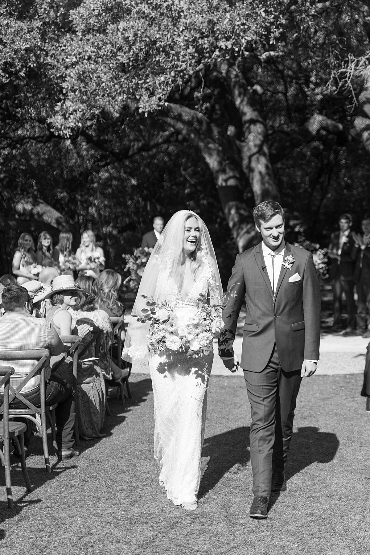 "We have chosen Texas as our home, and even though we aren't from here, we've absolutely loved living here and wanted to honor our chosen home on our day with a little western flair." A custom horseshoe logo, bolo ties, and cowboy boots encouraged..! This super fun western Mercury Hall Wedding was one for the books! Click through to see all of their fun custom wedding details!