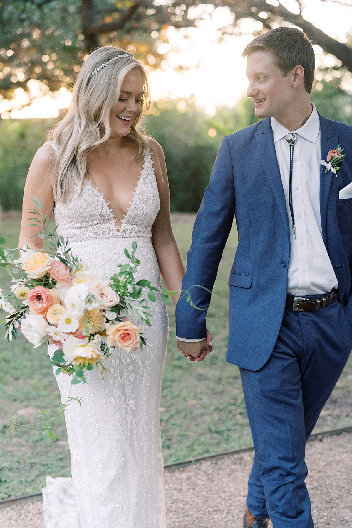 "We have chosen Texas as our home, and even though we aren't from here, we've absolutely loved living here and wanted to honor our chosen home on our day with a little western flair." A custom horseshoe logo, bolo ties, and cowboy boots encouraged..! This super fun western Mercury Hall Wedding was one for the books! Click through to see all of their fun custom wedding details!